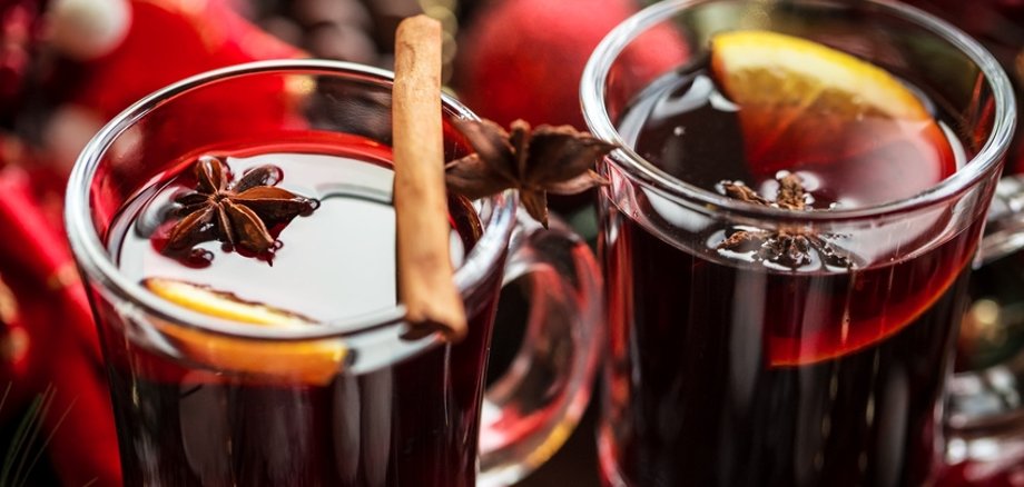 Christmas hot mulled wine with spices on a wooden table. The idea for creating greeting cards