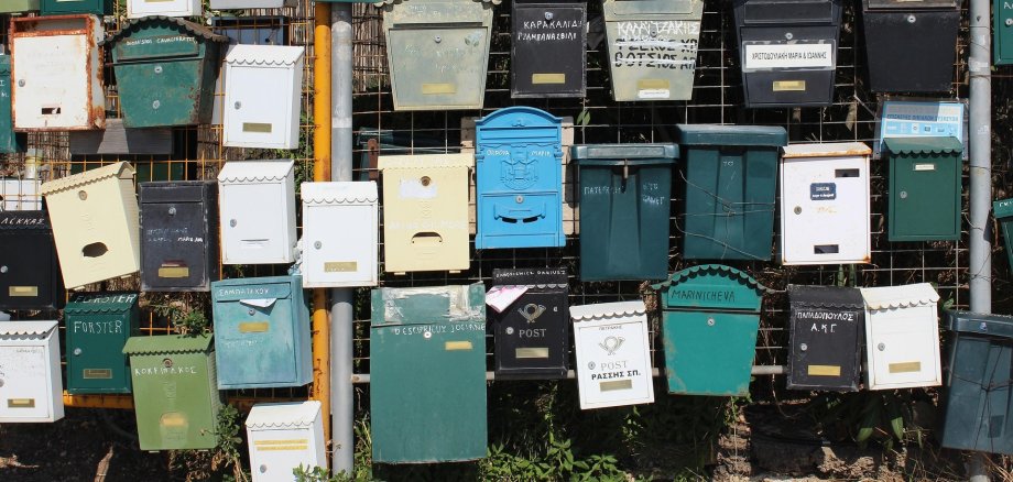Viele Briefkästen, die nebeneinander und untereinander aufgehängt sind.